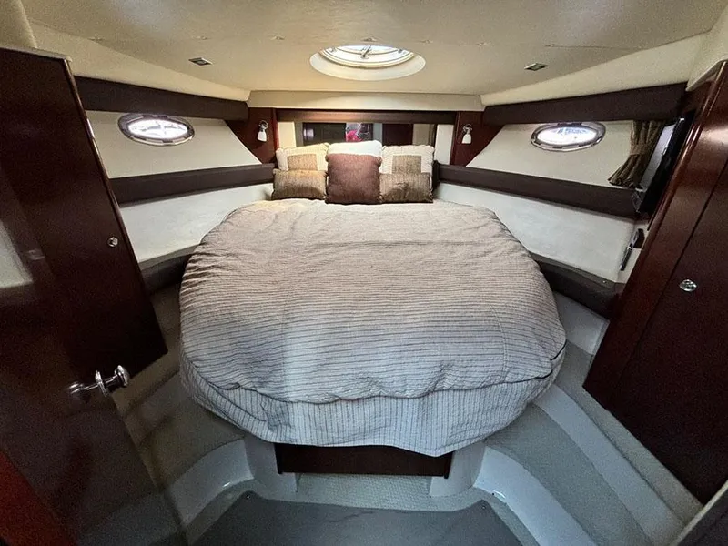 Slide: The Image of Luxurious bedroom interior of 2011 Meridian 391 Sedan yacht with circular windows. - 23
