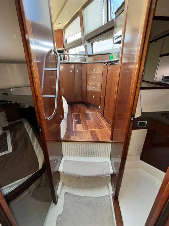Slide: The Image of Interior view of a 2011 Meridian 391 Sedan yacht, featuring wooden cabinetry and modern design. - 26