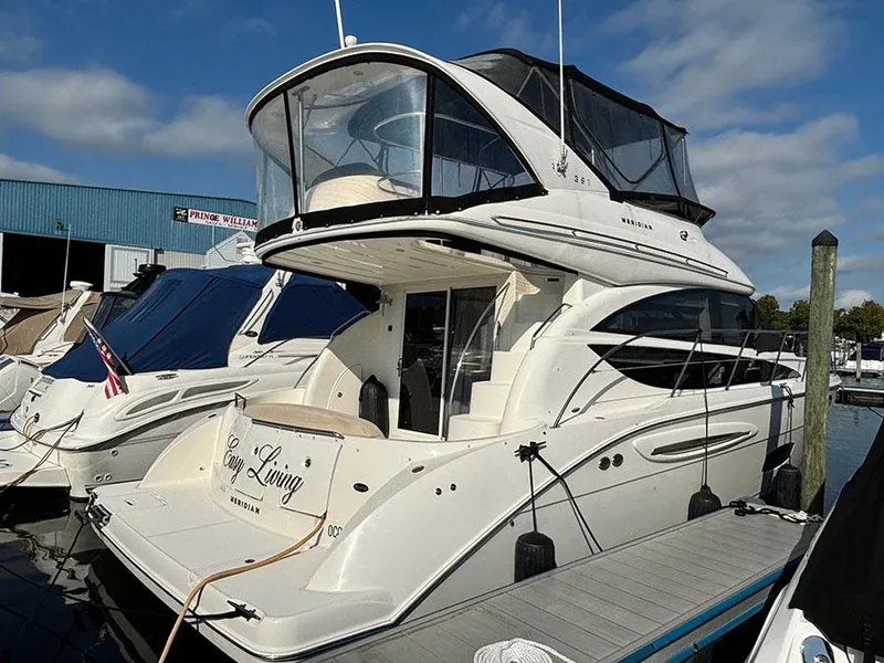 Slide: The Image of 2011 Meridian 391 Sedan yacht docked at marina, featuring elegant design and spacious upper deck. - 3