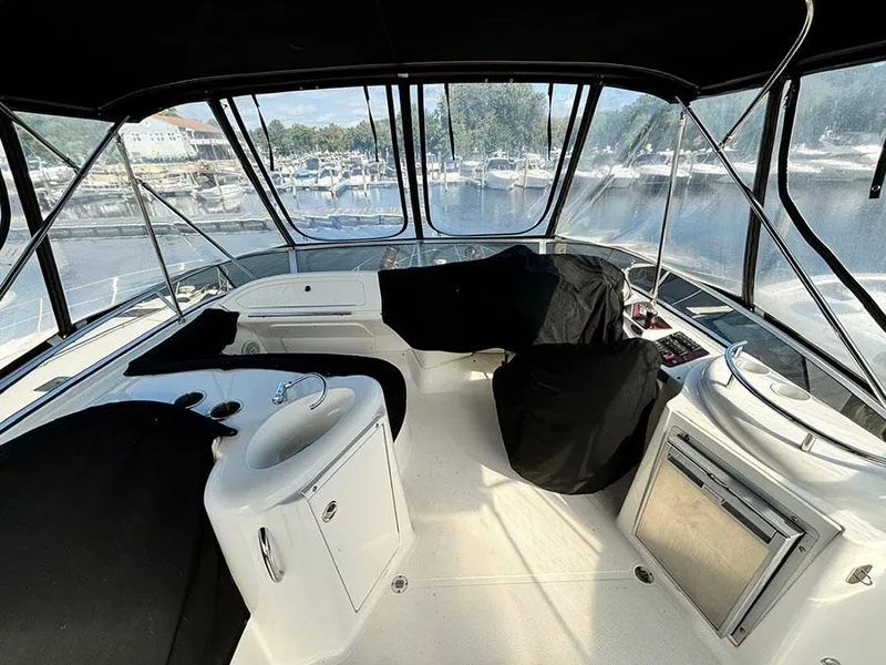 Slide: The Image of 2011 Meridian 391 Sedan yacht interior with covered seating and marina view. - 30