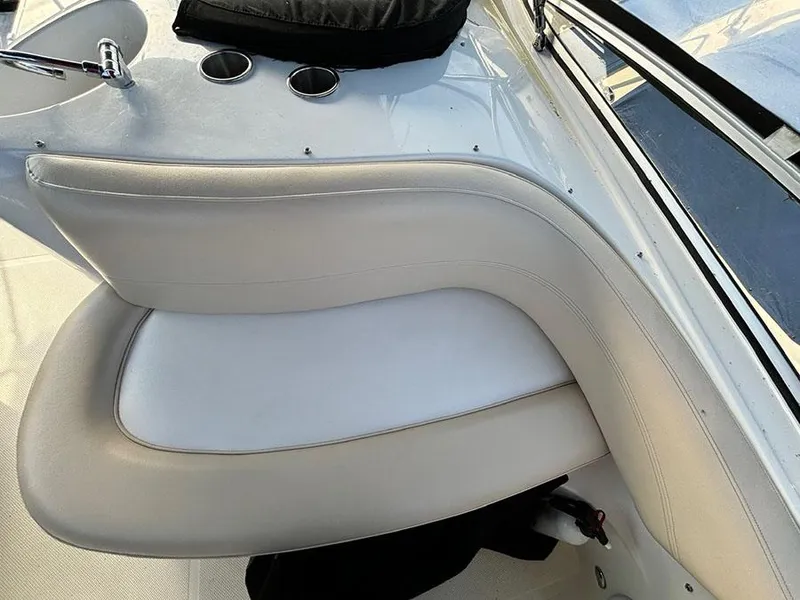 Slide: The Image of 2011 Meridian 391 Sedan boat interior seating with white upholstery and cup holders. - 31