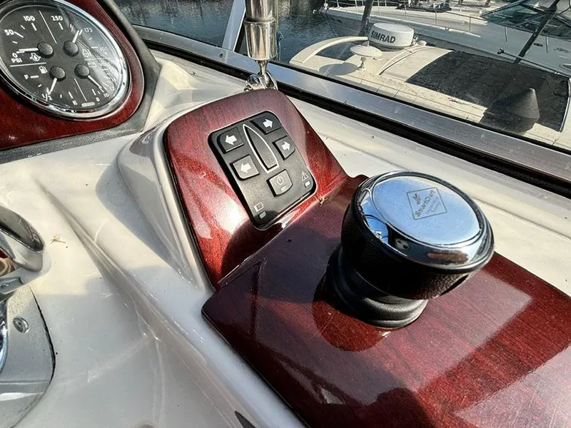 Slide: The Image of 2011 Meridian 391 Sedan dashboard with control panel and joystick, featuring wood accents. - 36