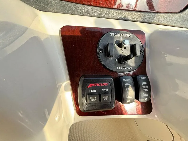 Slide: The Image of Control panel of a 2011 Meridian 391 Sedan with searchlight and trim tab switches. - 37