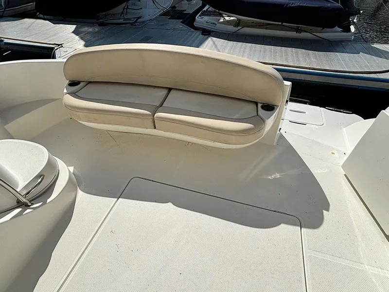 Slide: The Image of 2011 Meridian 391 Sedan boat seating area with beige cushions, docked at marina. - 5