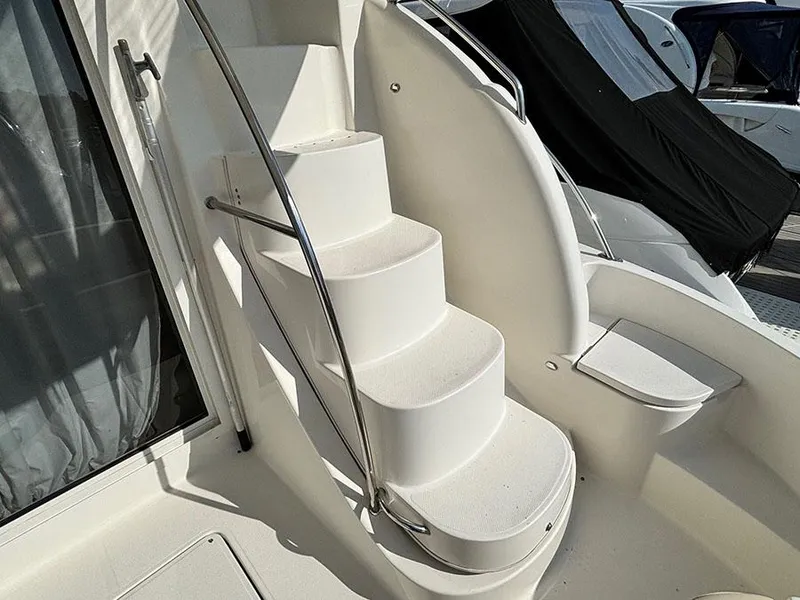 Slide: The Image of Staircase on 2011 Meridian 391 Sedan yacht, featuring sleek white design and stainless steel railing. - 6