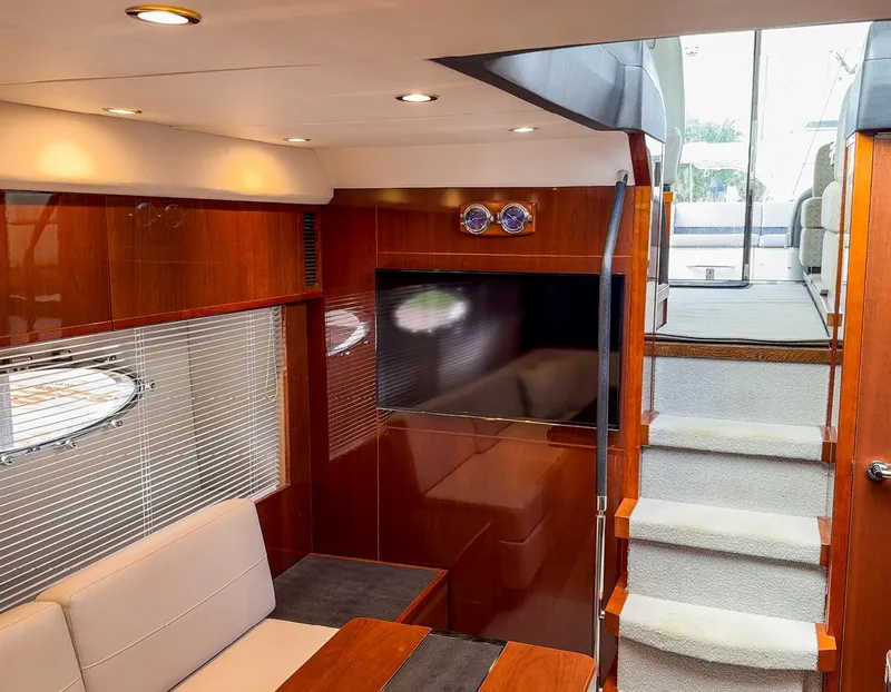 Slide: The Image of Luxurious interior of 2015 Princess V52 yacht with modern wood finishes and elegant seating. - 15
