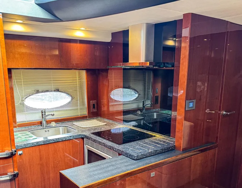 Slide: The Image of Luxurious kitchen interior of 2015 Princess V52 yacht with modern amenities and wood finish. - 17