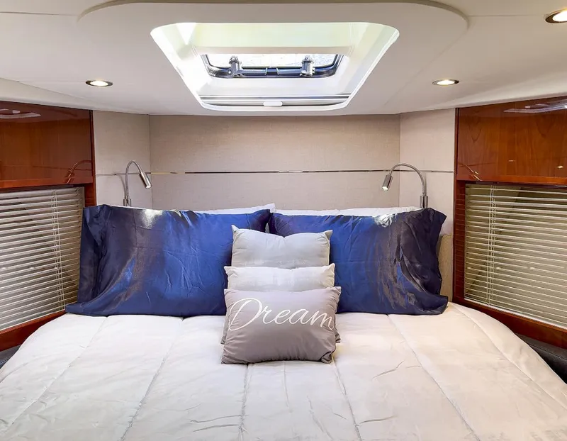 Slide: The Image of Luxurious 2015 Princess V52 yacht bedroom with skylight and plush bedding. - 19