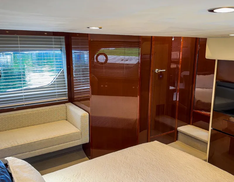 Slide: The Image of Luxurious interior of 2015 Princess V52 yacht with elegant wood paneling and cozy seating. - 21
