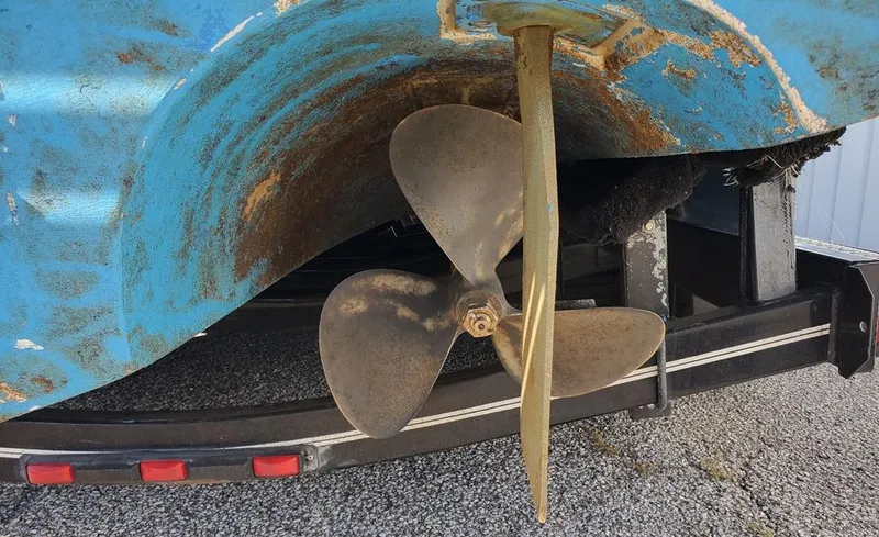 Slide: The Image of Propeller of 1989 Sea Ray 300 Weekender boat on trailer, showing wear and rust. - 33