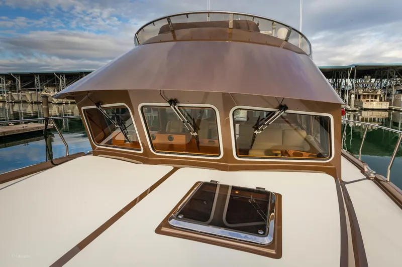 Slide: The Image of Coastal Craft 56 yacht, 2012 model, docked with inflatable boat on deck, marina background. - 10