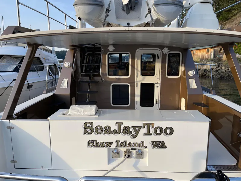 Slide: The Image of Outdoor deck of a 2012 Coastal Craft 56 yacht with storage cabinets and scenic marina view. - 14