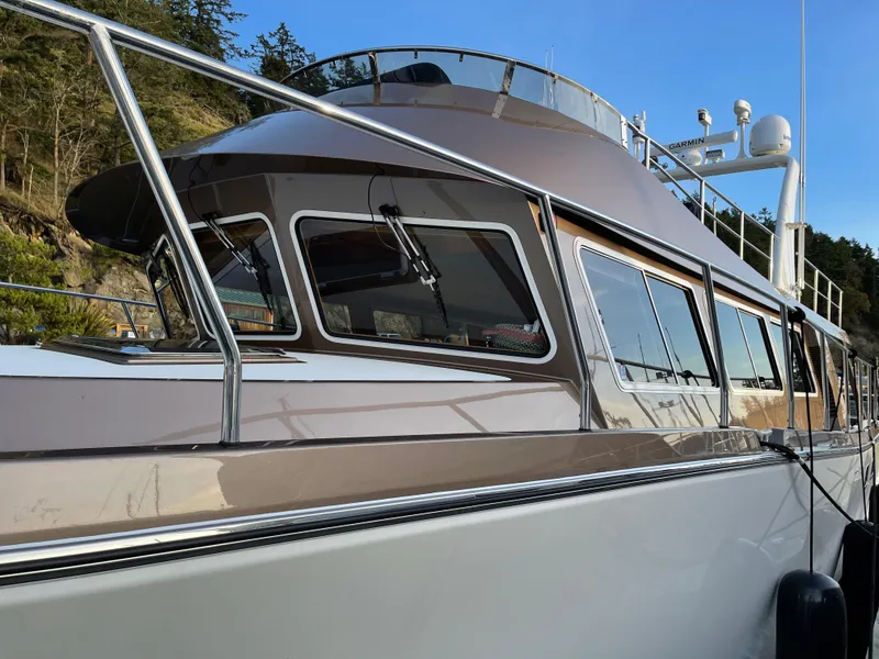 Slide: The Image of 2012 Coastal Craft 56 boat detail with metallic fixtures and porthole. - 18