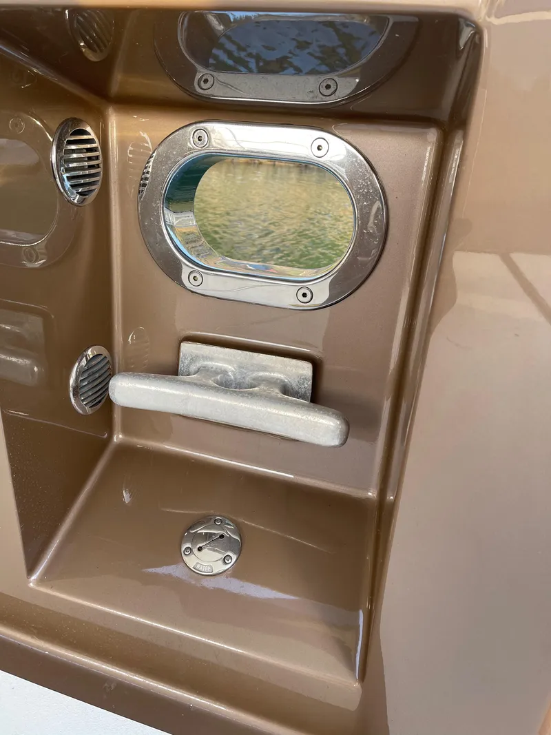 Slide: The Image of 2012 Coastal Craft 56 yacht with sleek steps and control panel by the water. - 19