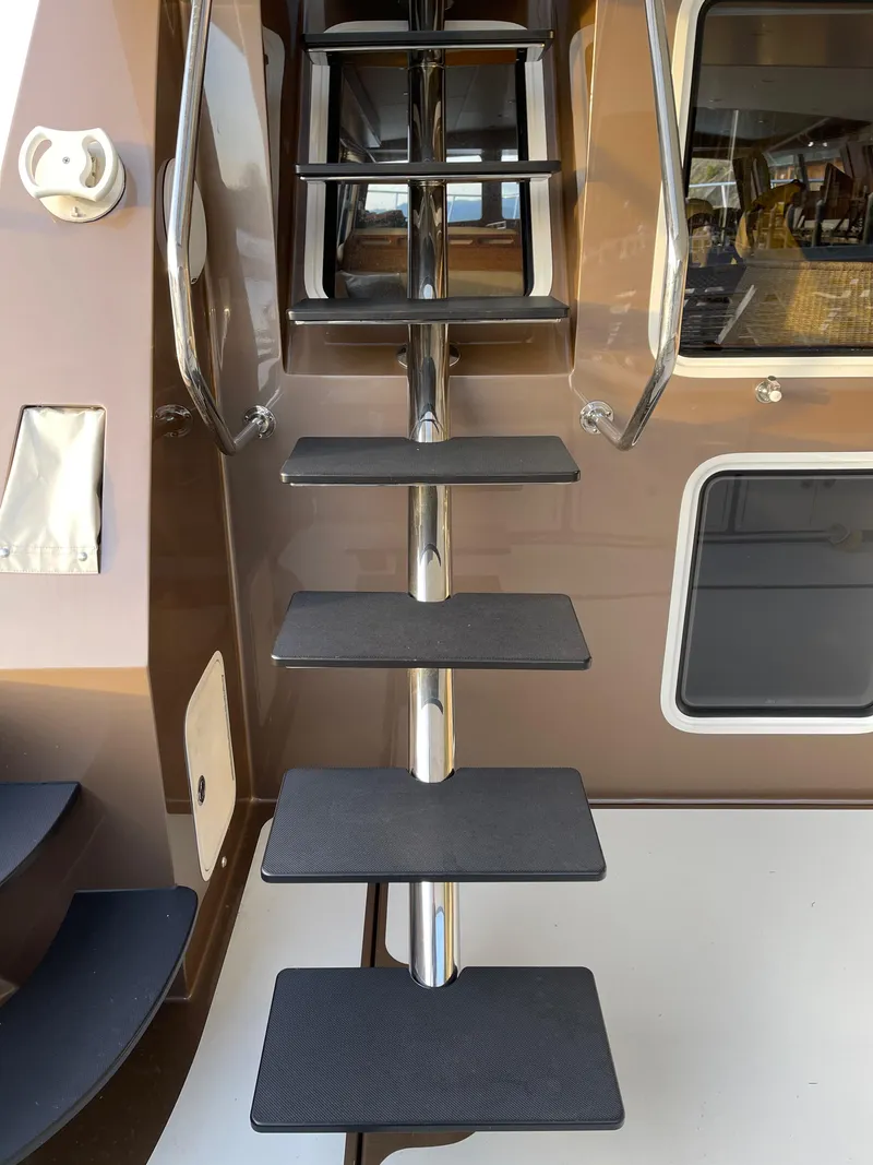 Slide: The Image of Luxury 2012 Coastal Craft 56 yacht with cushioned seating, docked at a scenic marina. - 21