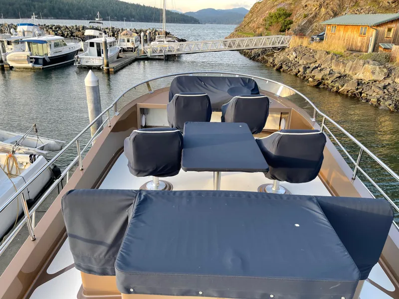 Slide: The Image of Covered seating area on a 2012 Coastal Craft 56 yacht docked at a marina. - 22