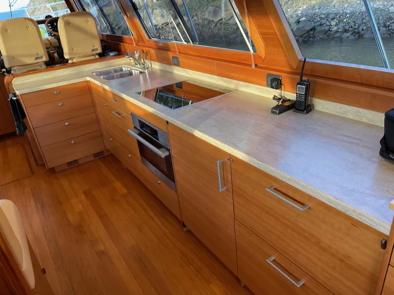 Slide: The Image of Interior of 2012 Coastal Craft 56 yacht with wooden cabinetry and window view. - 33