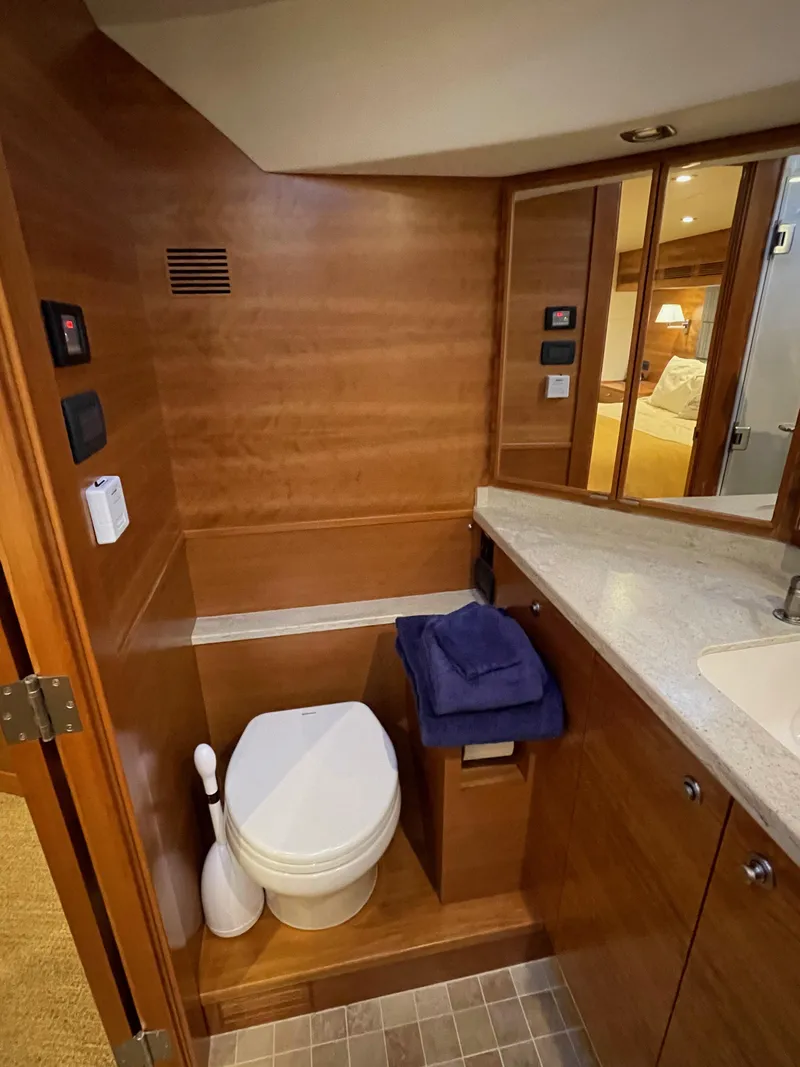 Slide: The Image of Wooden cabinetry inside a 2012 Coastal Craft 56 yacht, featuring drawers and a small window. - 44