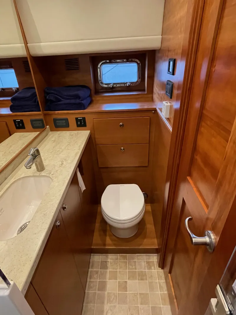 Slide: The Image of Luxurious bathroom in 2012 Coastal Craft 56 yacht, featuring modern fixtures and wooden cabinetry. - 46