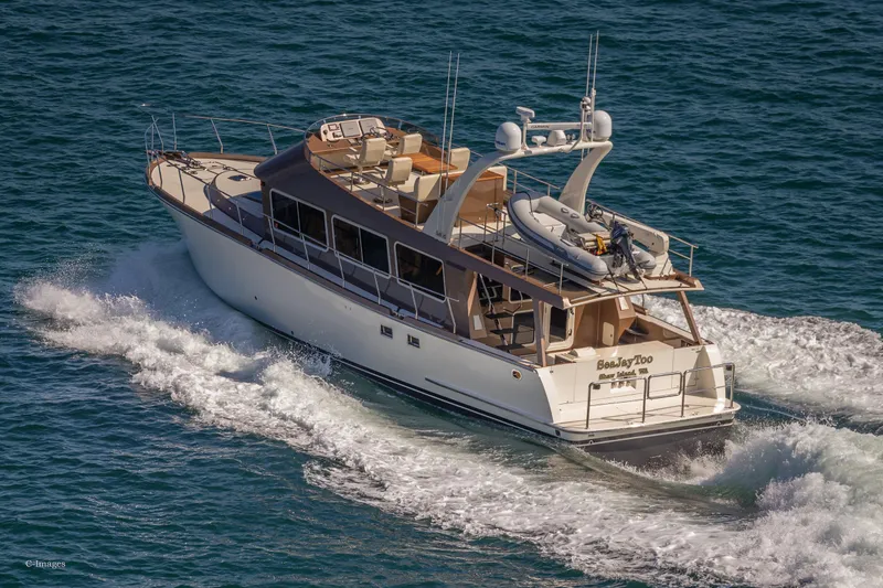 Slide: The Image of Luxury 2012 Coastal Craft 56 yacht cruising on open water. - 6