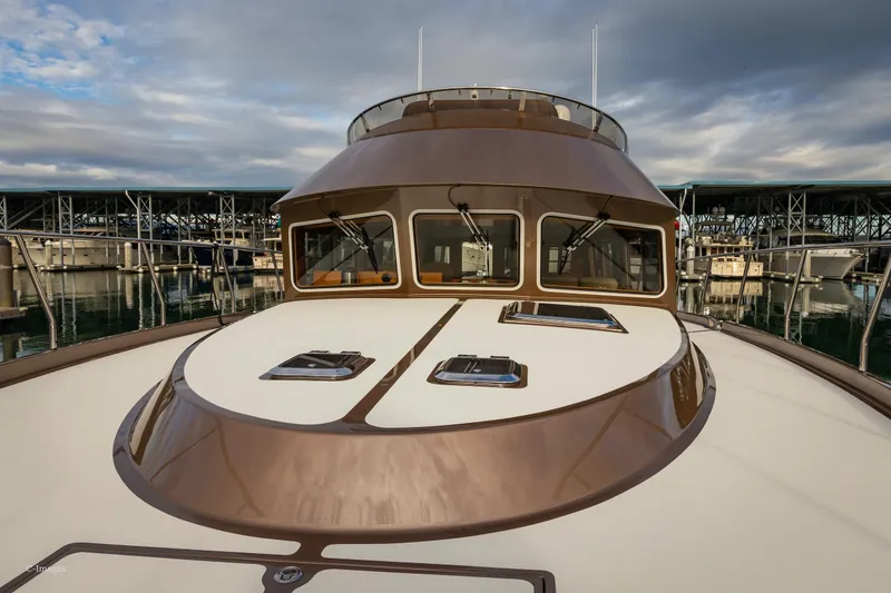Slide: The Image of 2012 Coastal Craft 56 yacht with sleek design, docked at marina. - 9