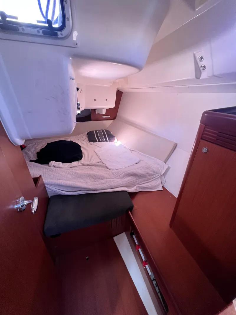 Slide: The Image of Cozy cabin interior of 2013 Beneteau 37 sailboat with bed and storage. - 13