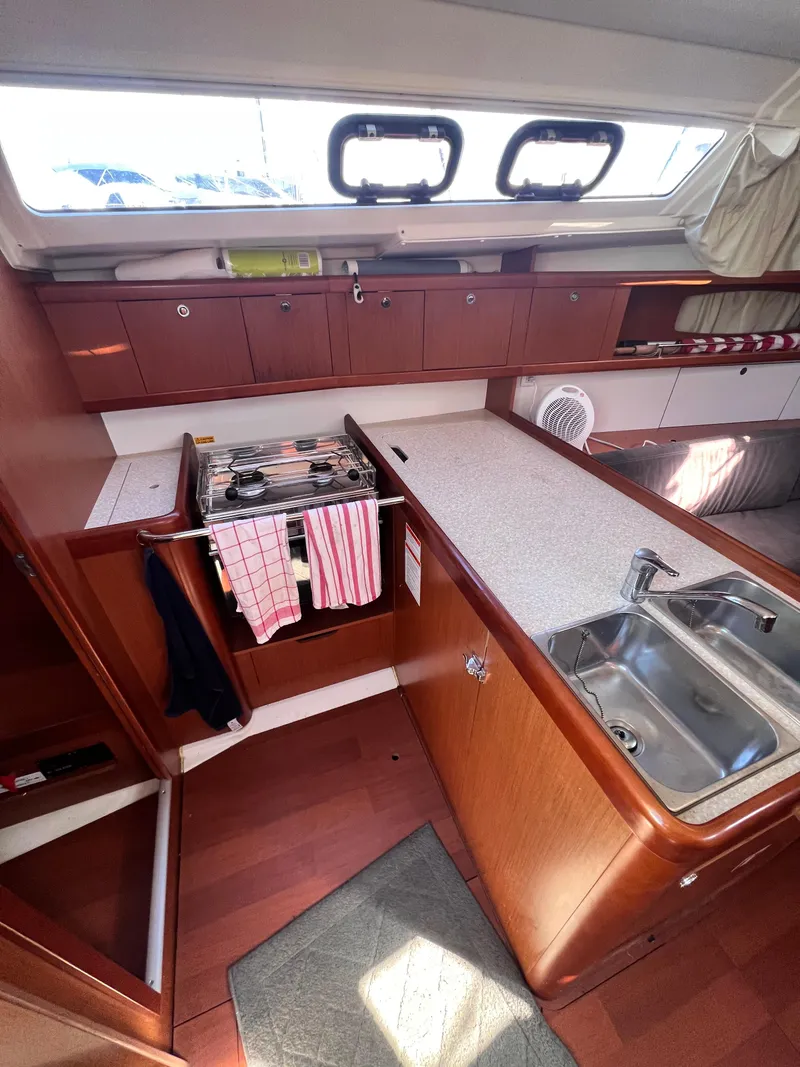 Slide: The Image of Interior of a 2013 Beneteau 37 sailboat kitchen with stove and sink. - 14