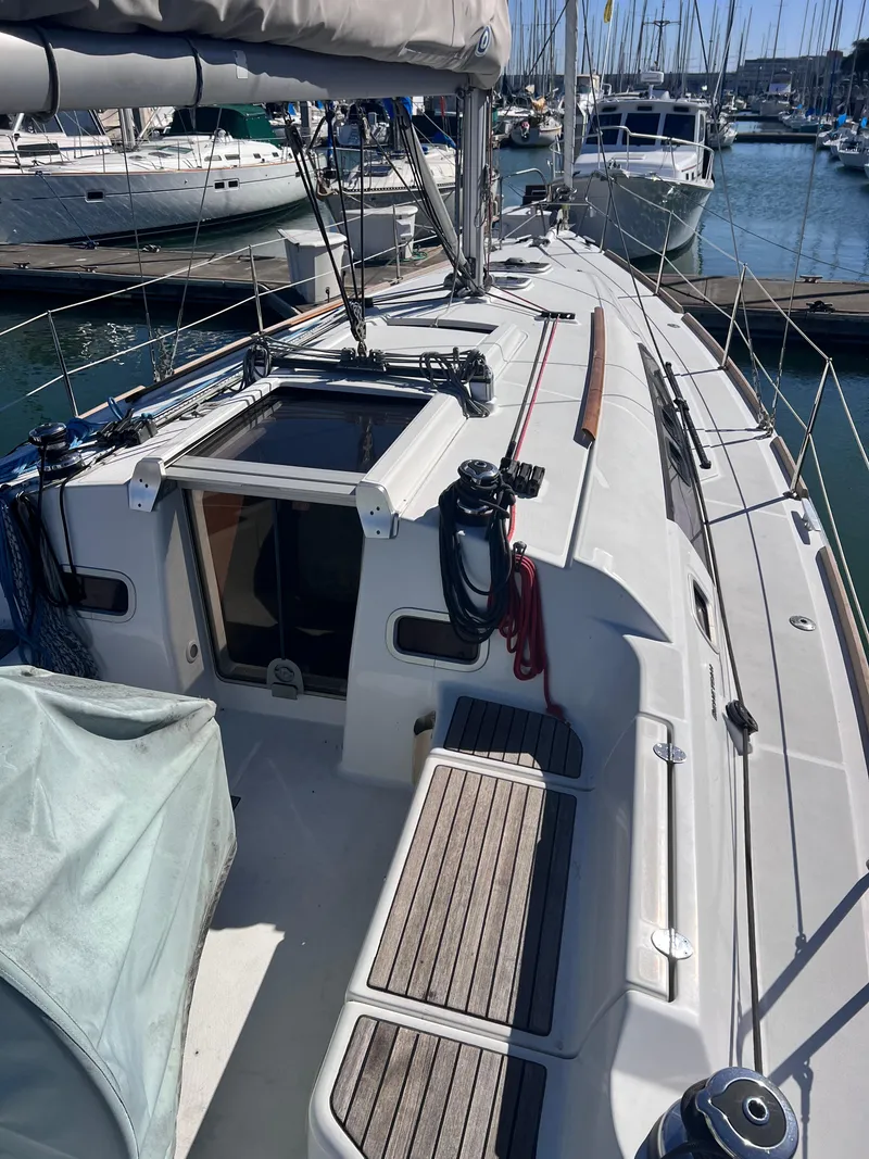 Slide: The Image of 2013 Beneteau 37 sailboat docked at marina, showcasing deck and cabin features. - 22