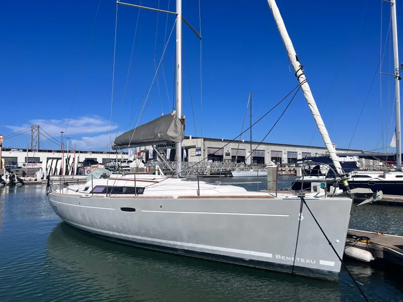 Slide: The Image of 2013 Beneteau 37 sailboat docked in marina under clear blue sky. - 24