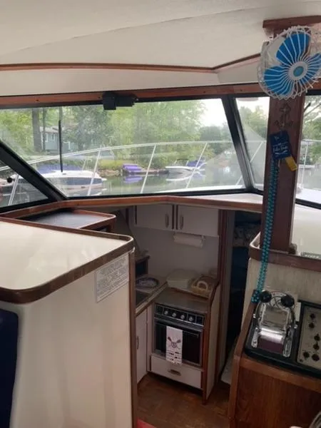Slide: The Image of Interior of 1985 Carver 3227 Convertible boat with kitchen and control panel. - 8