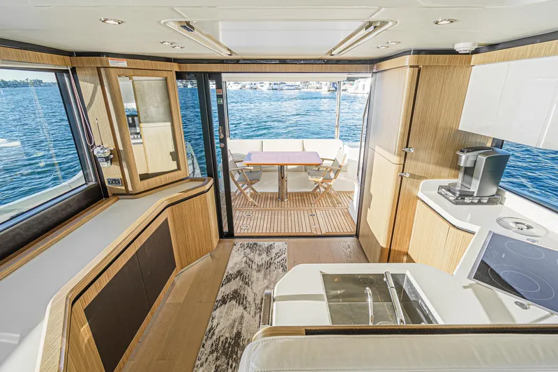 Slide: The Image of Luxurious 2017 Absolute NAVETTA yacht interior with modern kitchen and scenic ocean view. - 12