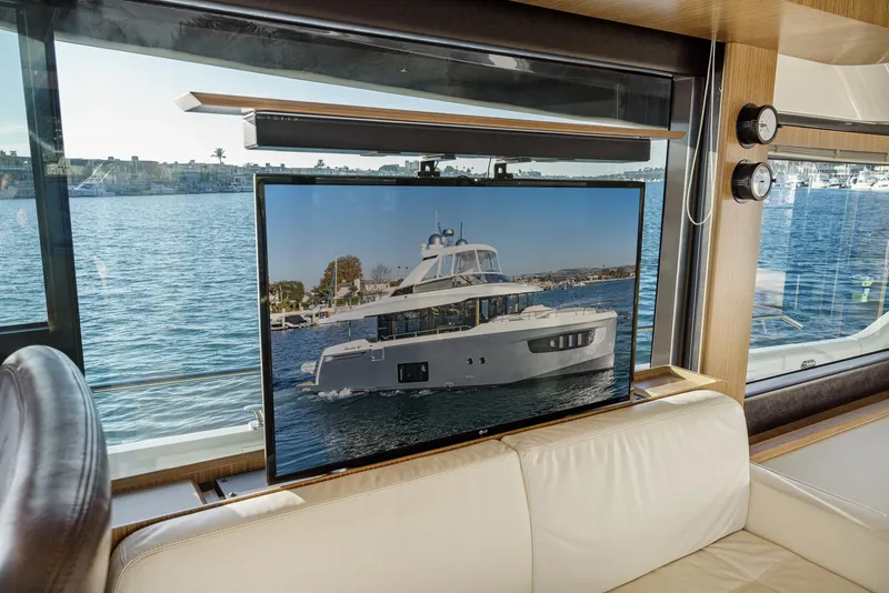 Slide: The Image of Interior of 2017 Absolute NAVETTA yacht with TV displaying yacht image. - 19