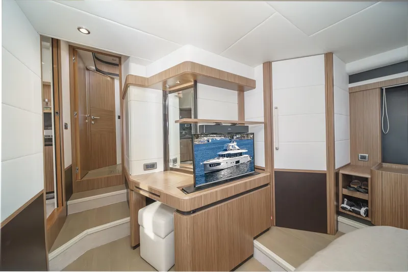 Slide: The Image of Luxurious interior of 2017 Absolute NAVETTA yacht with modern wood finishes and built-in TV. - 25