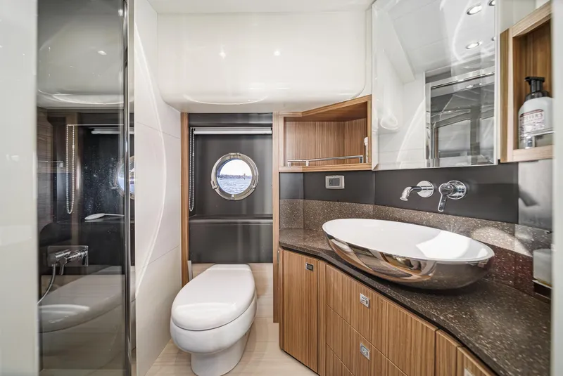 Slide: The Image of Luxurious 2017 Absolute NAVETTA yacht bathroom with modern fixtures and elegant wood cabinetry. - 27
