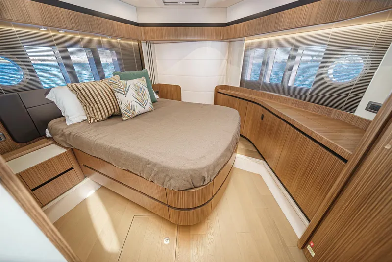 Slide: The Image of Luxurious 2017 Absolute NAVETTA yacht bedroom with modern wood design and ocean view windows. - 29