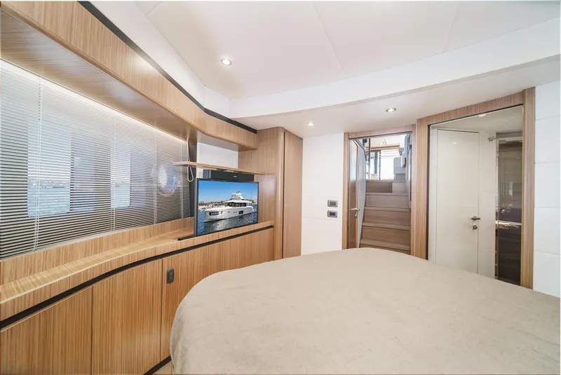 Slide: The Image of Luxurious 2017 Absolute NAVETTA yacht interior with modern wood paneling and flat-screen TV. - 33