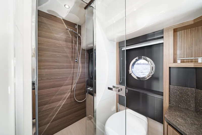 Slide: The Image of Luxurious 2017 Absolute NAVETTA yacht bathroom with modern shower and porthole window. - 34