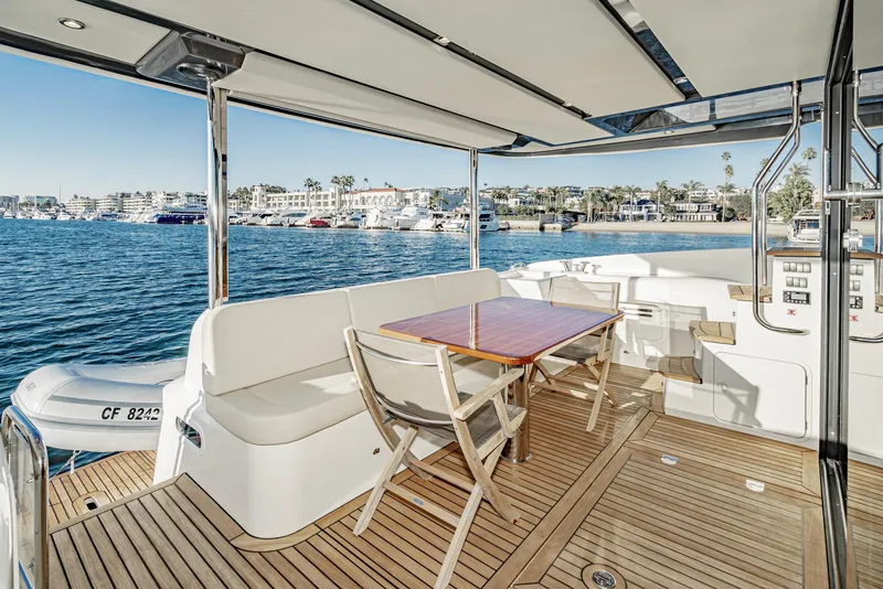 Slide: The Image of Luxury yacht deck with seating and table, overlooking marina. Absolute NAVETTA 2017 model. - 38