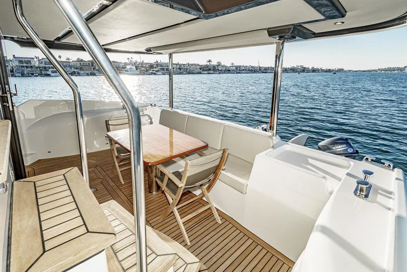 Slide: The Image of 2017 Absolute NAVETTA yacht deck with seating, table, and ocean view. - 41