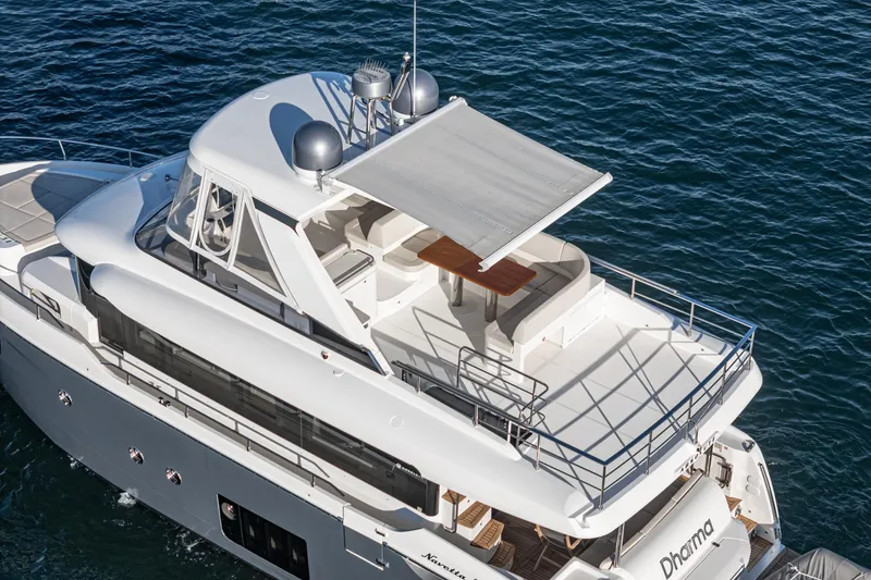 Slide: The Image of Luxury 2017 Absolute NAVETTA yacht with spacious deck and seating area on the water. - 44