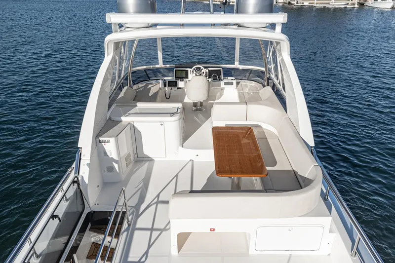 Slide: The Image of Luxurious 2017 Absolute NAVETTA yacht deck with seating and table on calm water. - 45