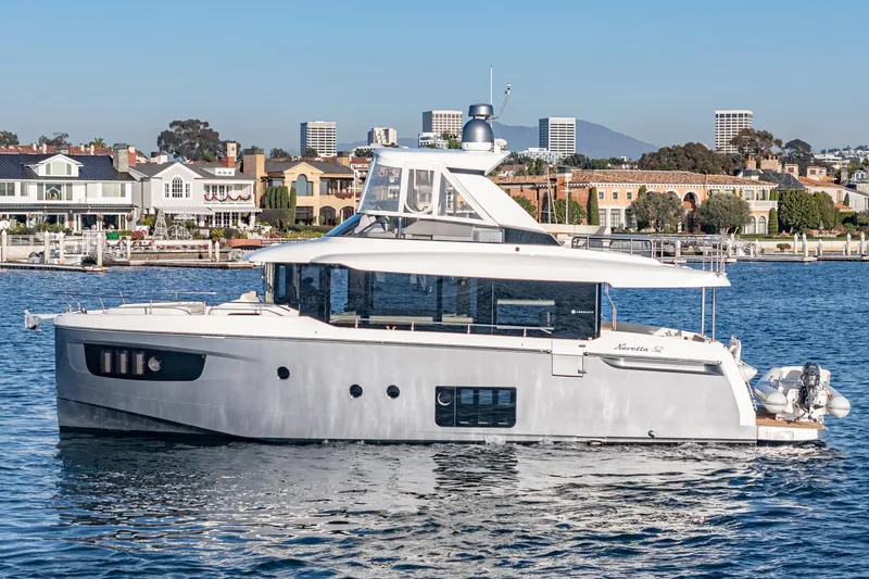 Slide: The Image of 2017 Absolute NAVETTA yacht cruising near waterfront homes. - 47