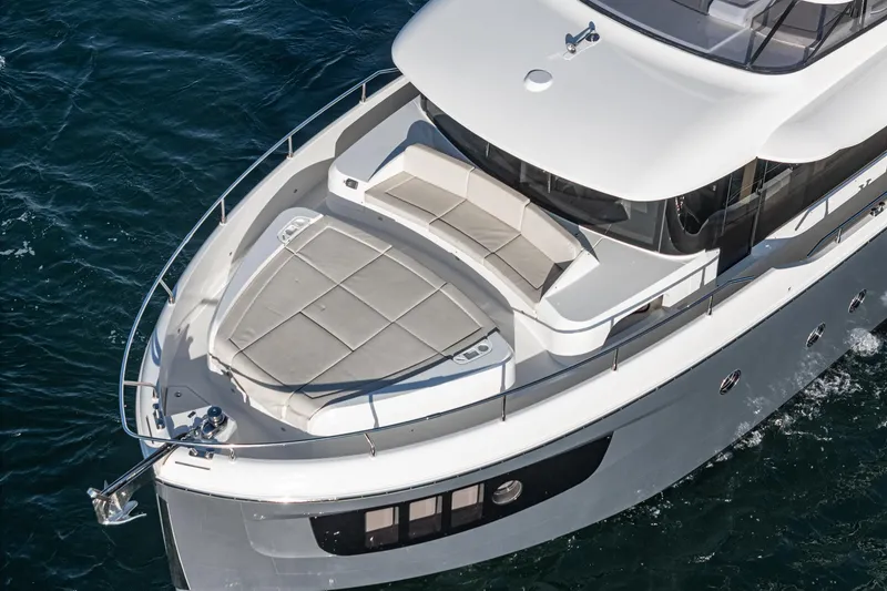 Slide: The Image of 2017 Absolute NAVETTA yacht with spacious deck and seating, cruising on blue waters. - 5