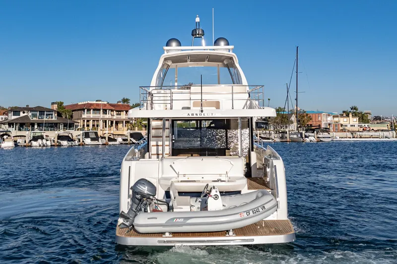 Slide: The Image of Luxury 2017 Absolute NAVETTA yacht docked in marina, clear blue sky. - 53