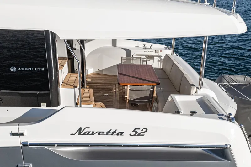 Slide: The Image of Luxury Absolute Navetta 52 yacht, 2017 model, featuring elegant outdoor seating and dining area. - 57