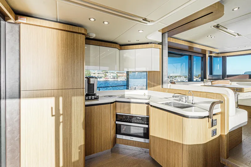 Slide: The Image of Luxurious 2017 Absolute NAVETTA yacht interior with modern kitchen and scenic ocean views. - 9