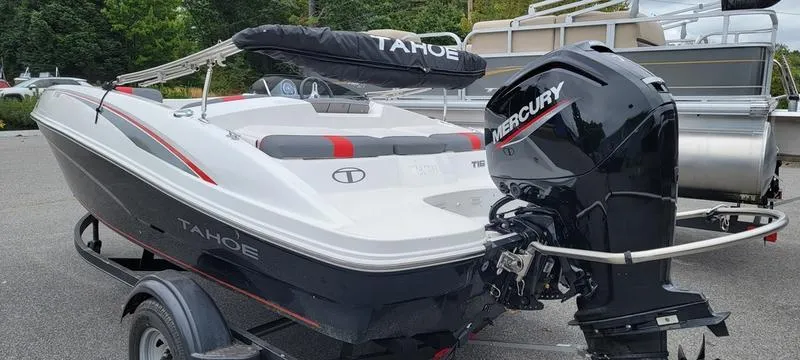 Slide: The Image of 2022 Tahoe T16 boat with Mercury engine on trailer, parked outdoors. - 11