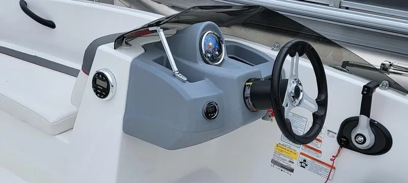 Slide: The Image of 2022 Tahoe T16 boat dashboard with steering wheel and controls. - 5