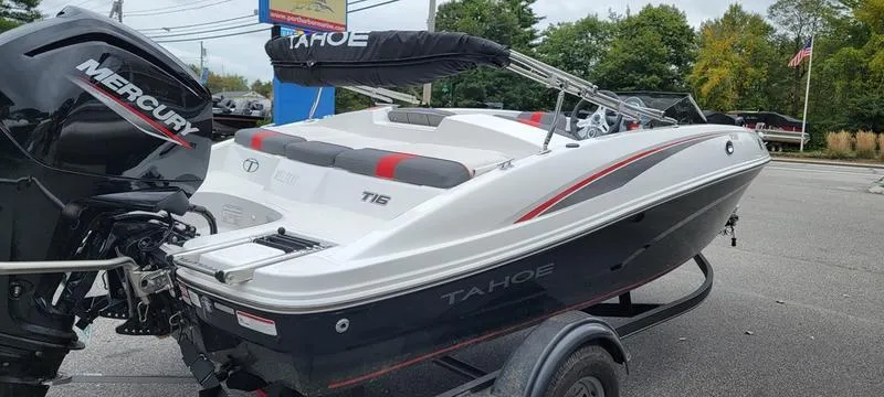 Slide: The Image of 2022 Tahoe T16 boat with Mercury engine on trailer, parked outdoors. - 6