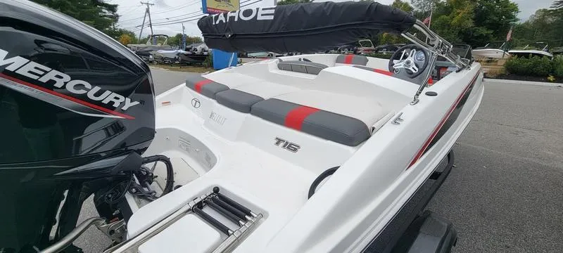 Slide: The Image of 2022 Tahoe T16 boat with Mercury engine, white and red interior, parked outdoors. - 7